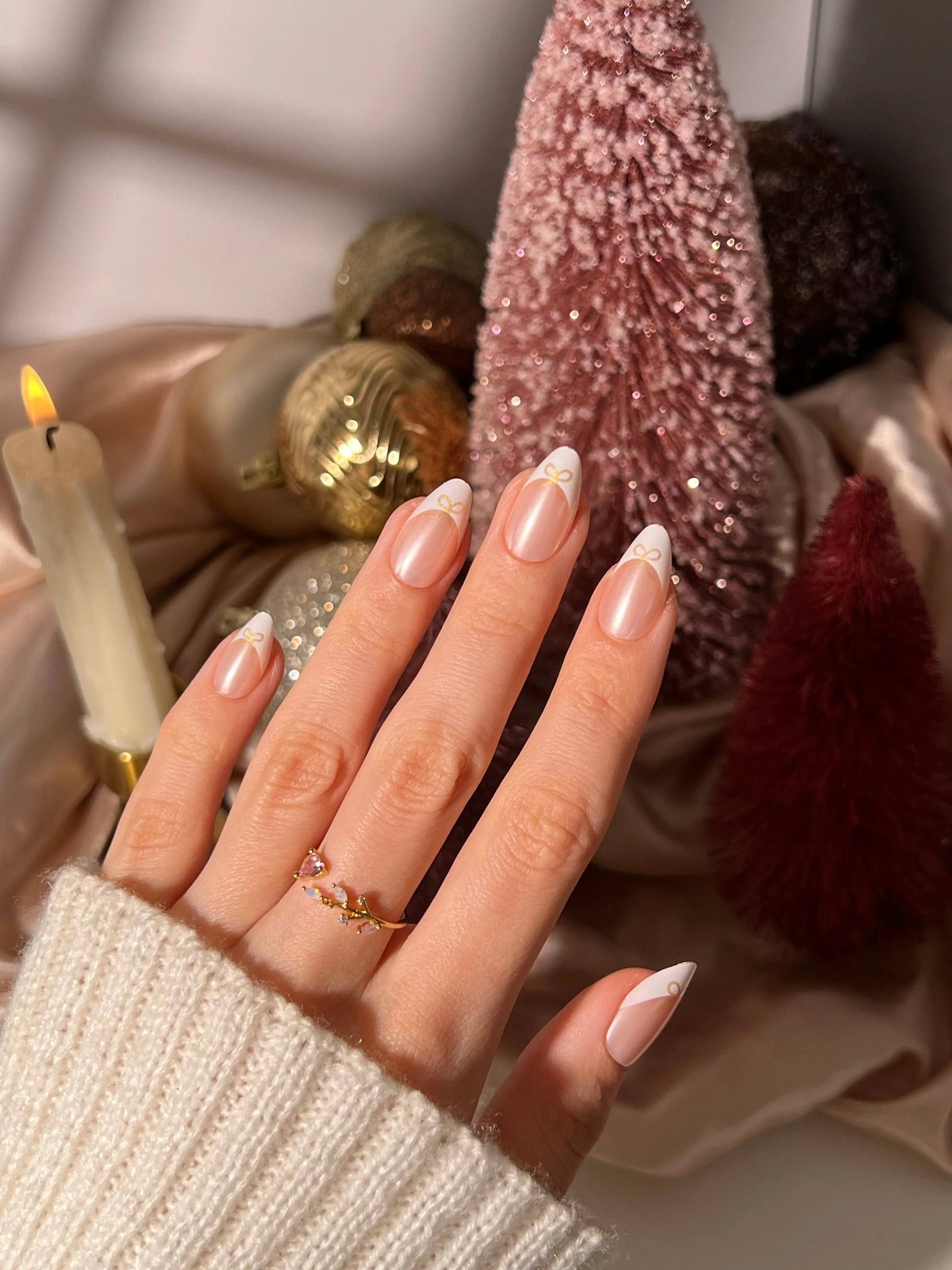 Frenchie Bow Press-On Nail Set featuring almond-shaped tips with a pearl chrome finish and delicate bow accents. These high-quality press-on nails offer a salon-quality look with long-lasting wear, designed for easy at-home application. The set includes multiple nail sizes, nail glue, a cuticle stick, nail file, prep pad, and a reusable storage box. Ideal for elegant, mess-free manicures that last up to two weeks._NextGen Glam

